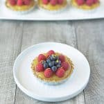 No bake berry lemon tartlets are an easy and very spring-like dessert. With a lemon graham cracker crust, delicious lemon curd filling and topped with fresh berries these tartlets are brightly colored berry treats.