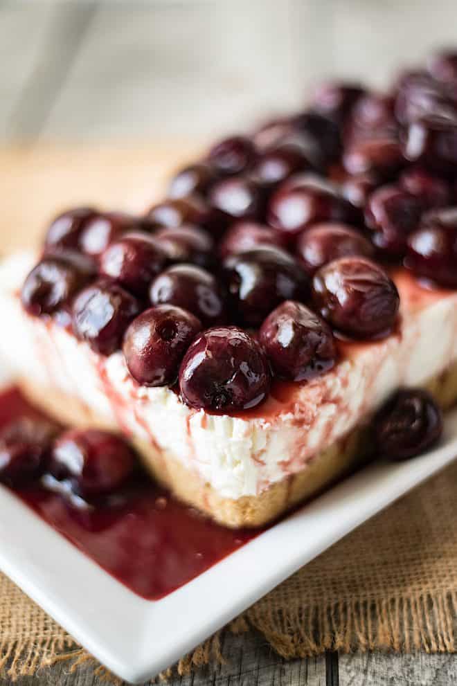 A closeup of the dark cherries on top of the cherry lemon cheesecake