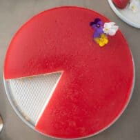 Strawberry cheesecake viewed from overhead with a slice removed