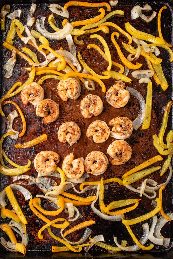 Shrimp, peppers and onions on a sheet tray