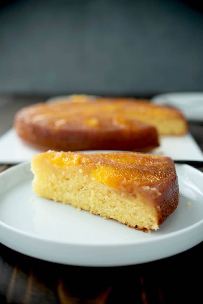 A slice of cake on a white plate showing the inside