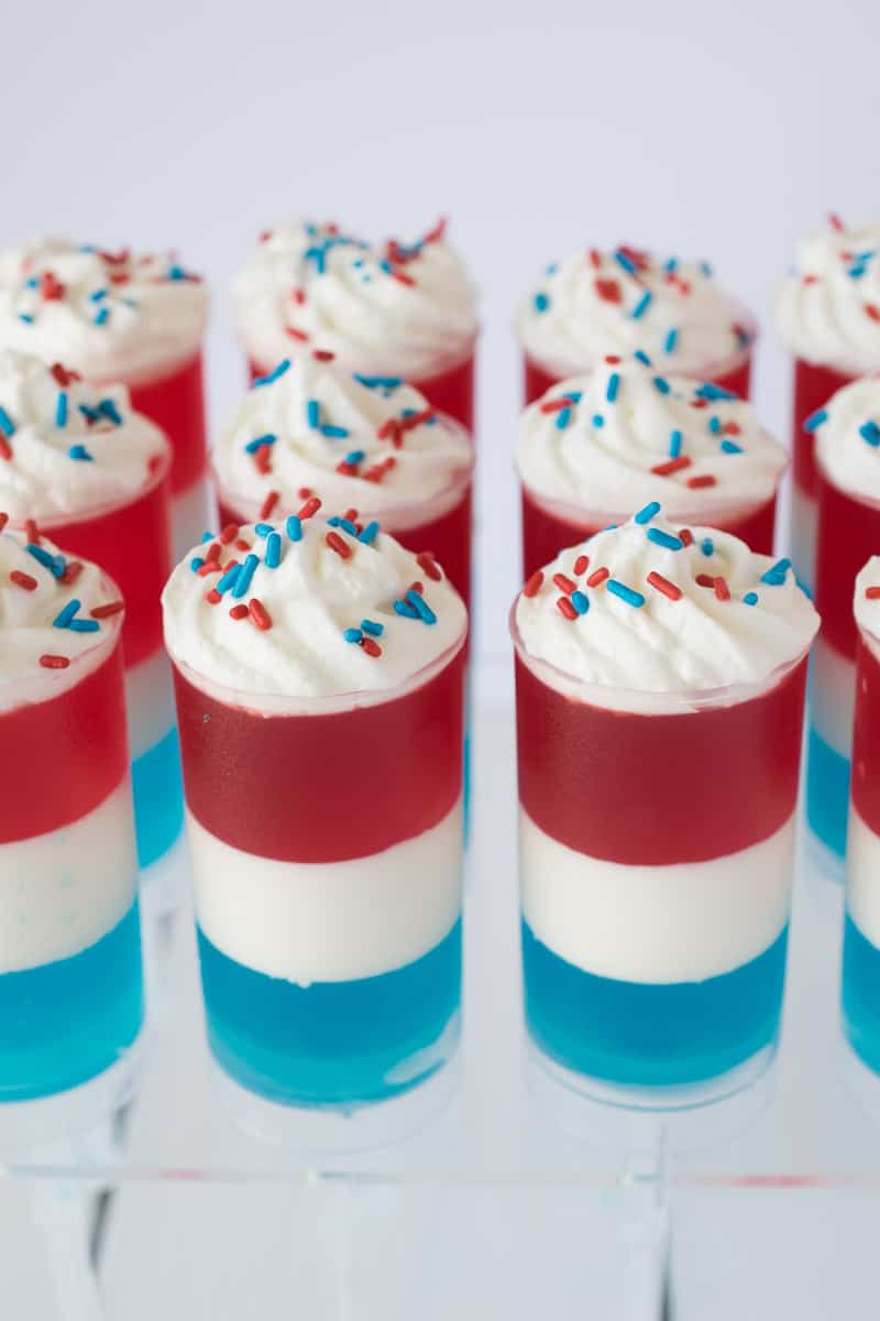 These Patriotic Jello and cream push pops are easy to make and so much fun to look at and eat! Get your kids involved in not only the eating, but the making of the layers of Jello, lemon cream and sprinkles. Fun for 4th July or Memorial Day celebrations.