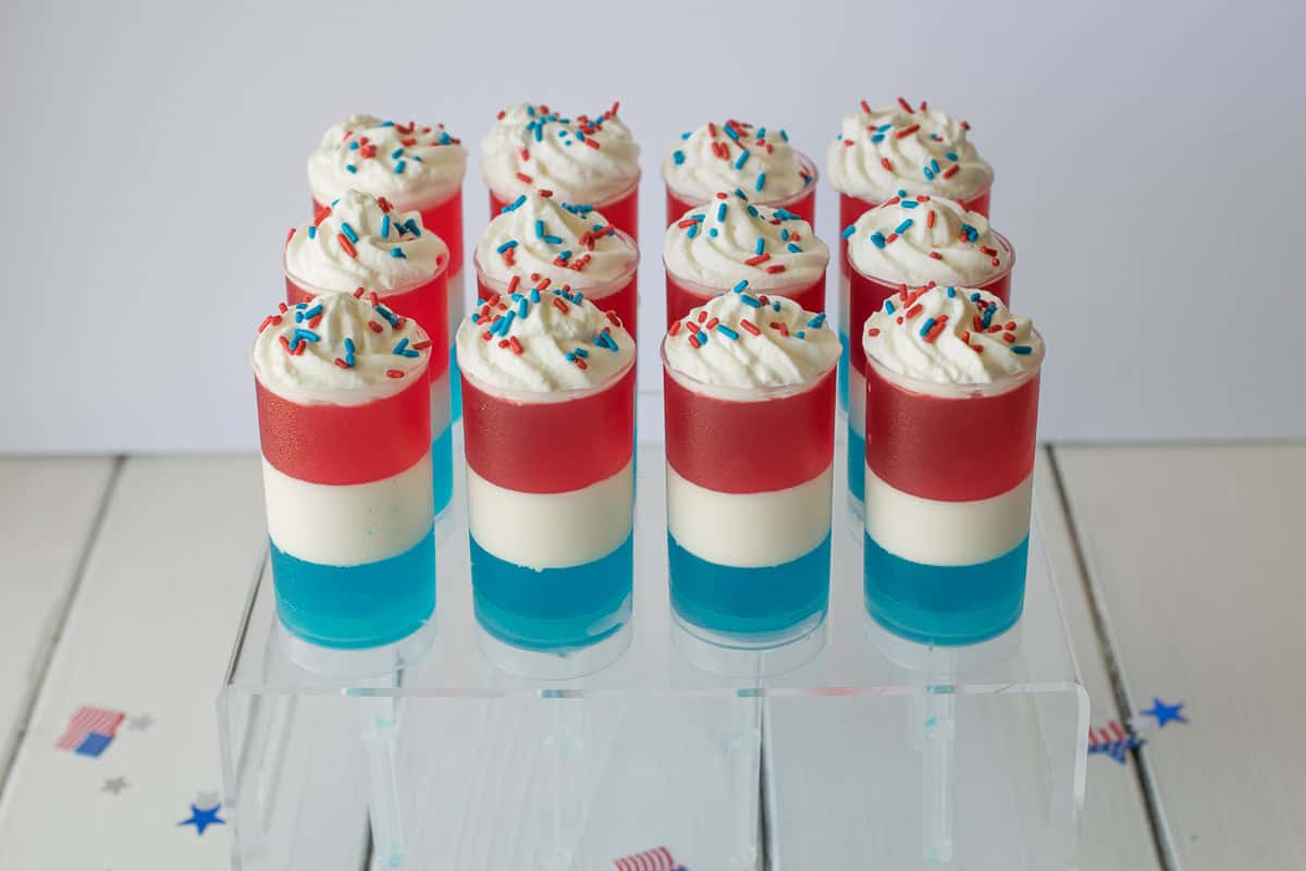 These Patriotic Jello and cream push pops are easy to make and so much fun to look at and eat! Get your kids involved in not only the eating, but the making of the layers of Jello, lemon cream and sprinkles. Fun for 4th July or Memorial Day celebrations.