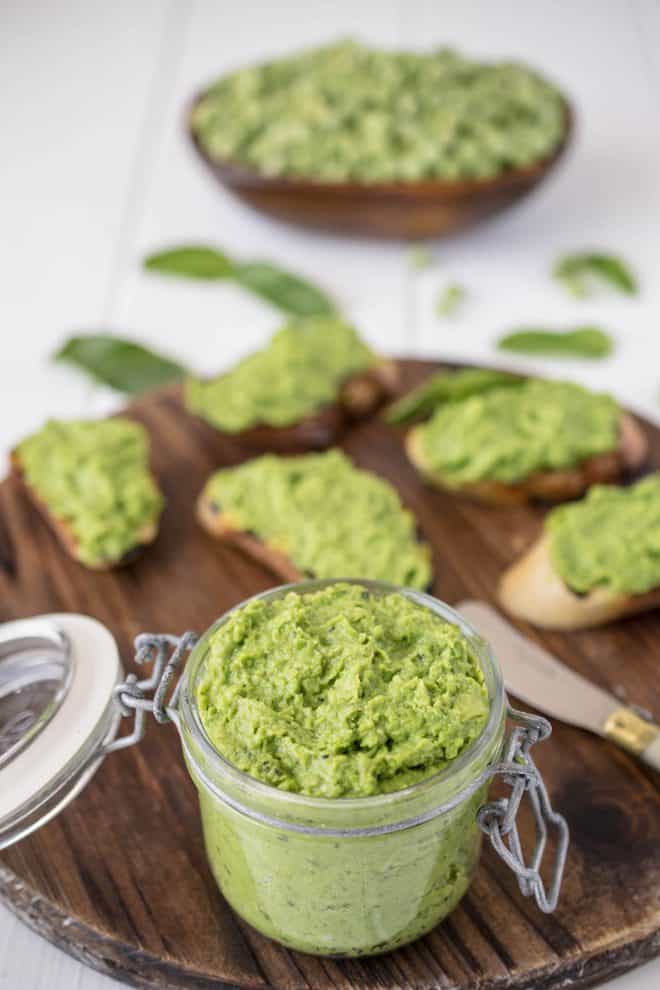 Pea & mint pesto in a jar with some on crostini in background