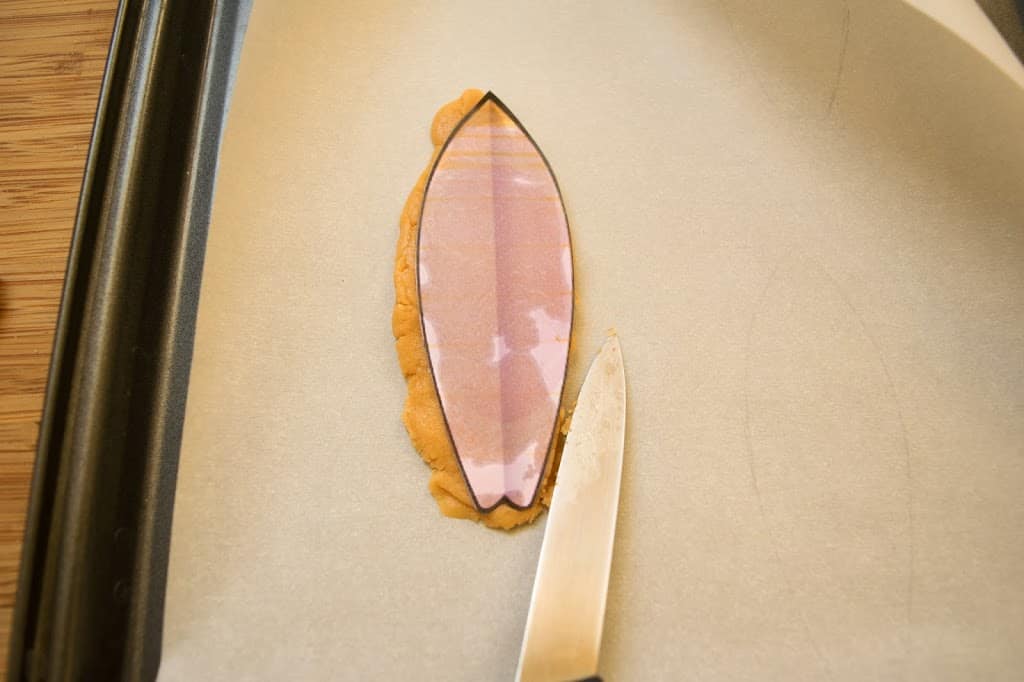 This Graham Cracker Beach House & Peanut Butter Cookie Surfboards is a fun, beach-themed decoration that was used for a Christmas party table centerpiece.