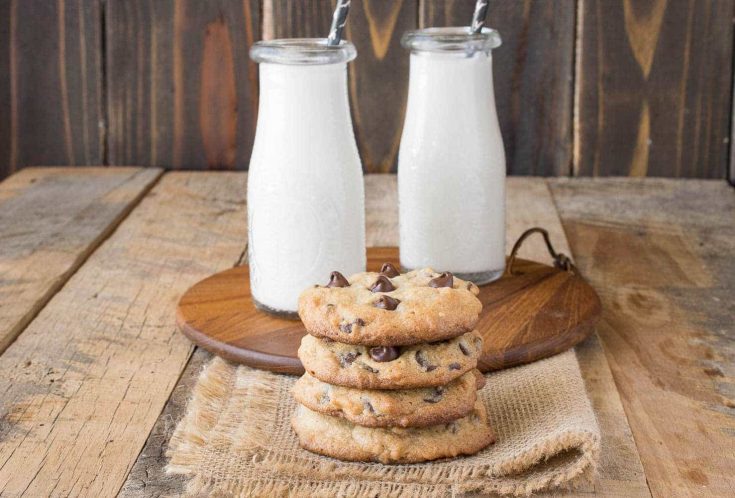 A side shot of a stack of cookies with milk
