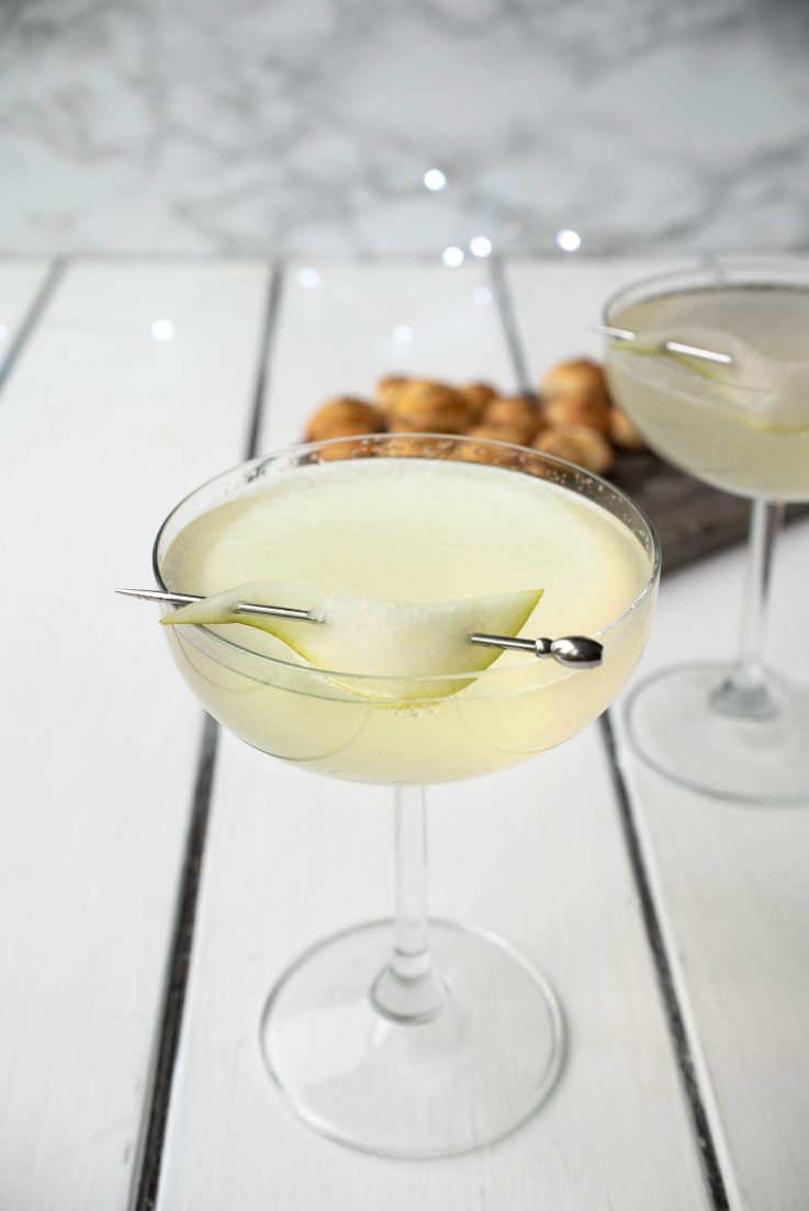 Pear Ginger Champagne Cocktail in a stemmed glass garnished with a pear slice