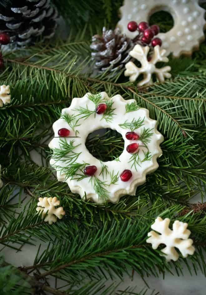 Christmas wreath and snowflake cookies on pine fern with pine cones
