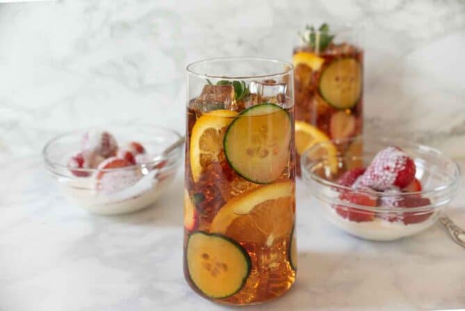 A glass of Pimm's No. 1 cup served with strawberries and cream for Wimbledon