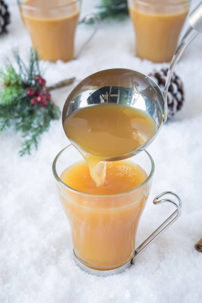 Pouring the warm drink into a glass cup