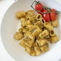Pistachio pesto pasta viewed from overhead on a white plate