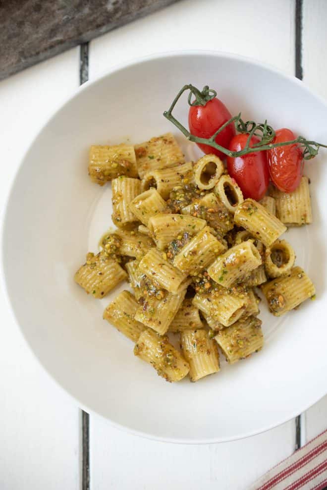 Pistachio pesto pasta viewed from overhead on a white plate