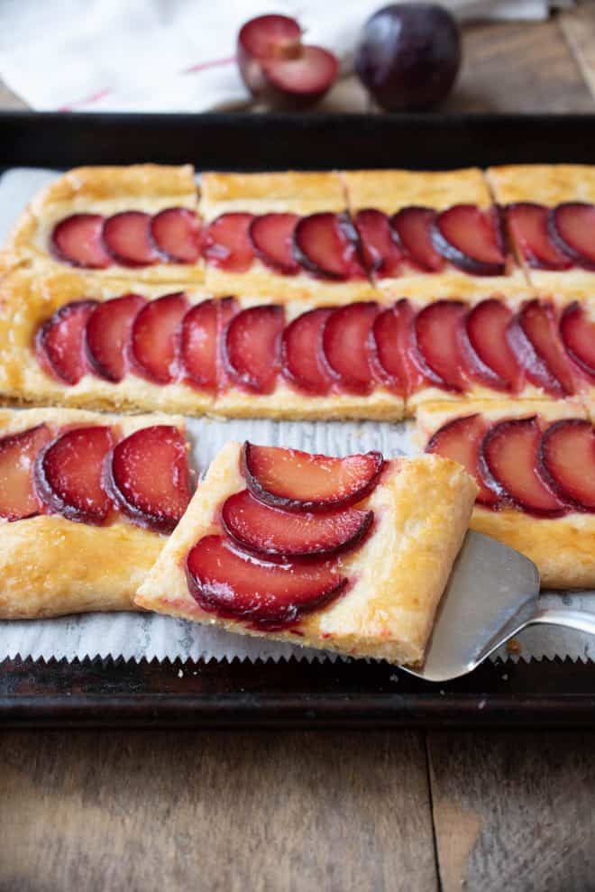 A square slice of plum tart with cornmeal crust