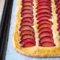 A closeup of a plum tart showing the pretty slices