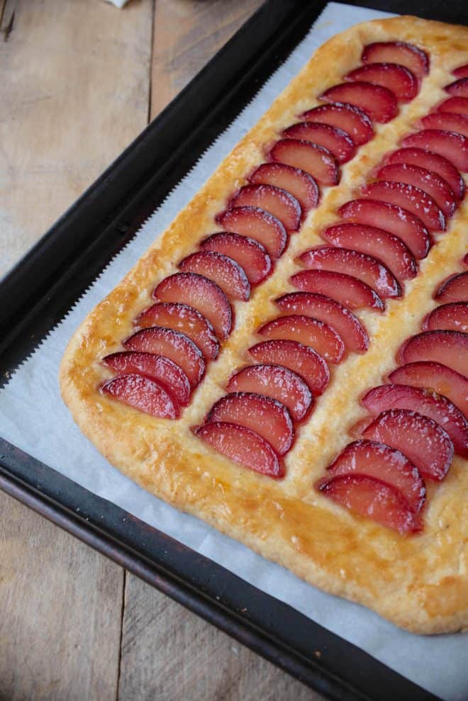 The corner of a plum tart before slicing