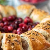A closeup of the sausage roll wreath with cuts showing the sausage inside