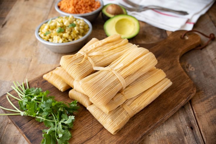 Tamales with fresh cilantro, corn, rice and avocado