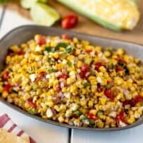 Corn kernels with tomato and chiles in a bowl