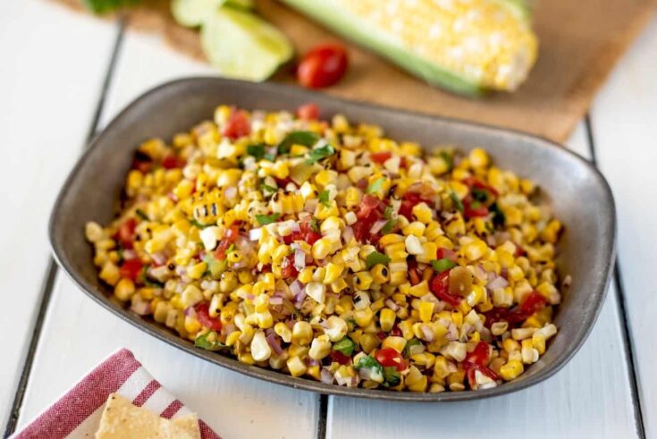 Corn kernels with tomato and chiles in a bowl