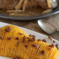 Half of a butternut squash on a white serving plate