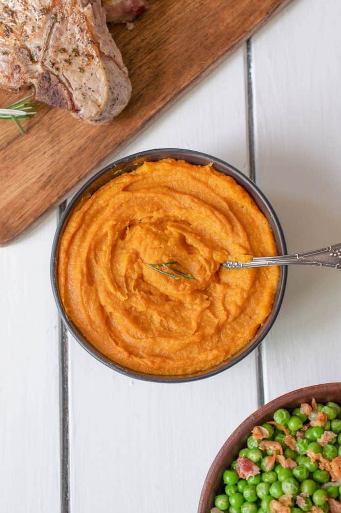 A complete meal of pork chops, peas and carrot parsnip puree