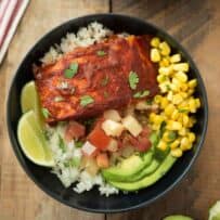 Fresh corn, avocado slices, salsa and salmon in a bowl
