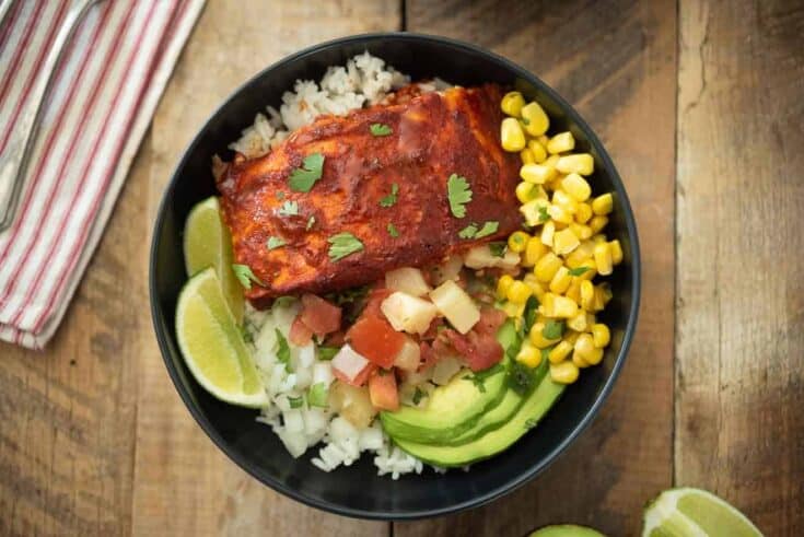 Fresh corn, avocado slices, salsa and salmon in a bowl