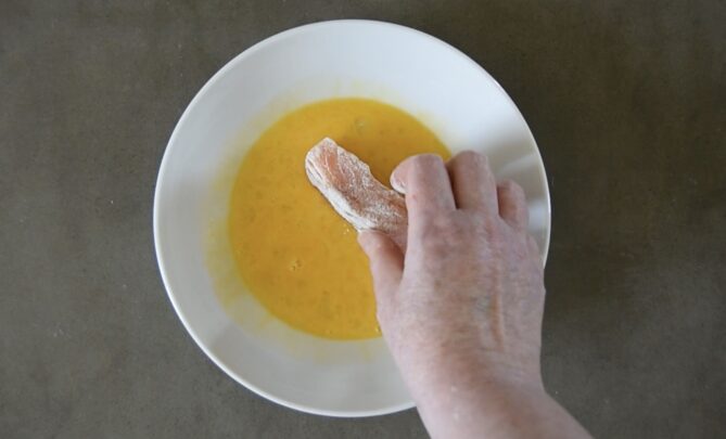Dipping salmon into beaten egg