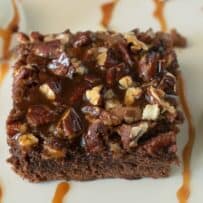 The light hitting the shiny caramel on top of the brownie with caramel drizzles and whipped cream