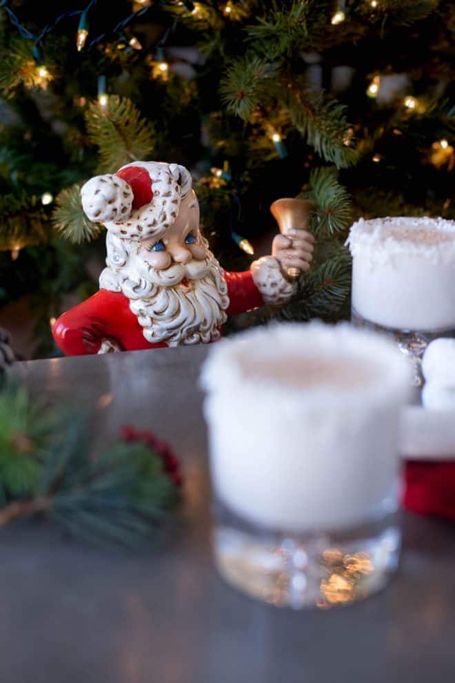 A ceramic Santa looking at his glass of Rum Spiked Milk