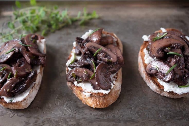 3 sautéed mushroom and rosemary bruschetta on a serving platter