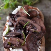Meaty mushrooms on top of crusty bread with creamy ricotta