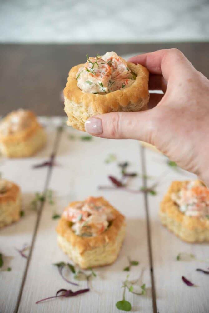 Holding a shrimp and avocado puff pastry shell