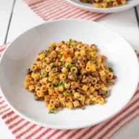 Ditalini pasta mixed with lentil sauce served garnished with chopped parsley