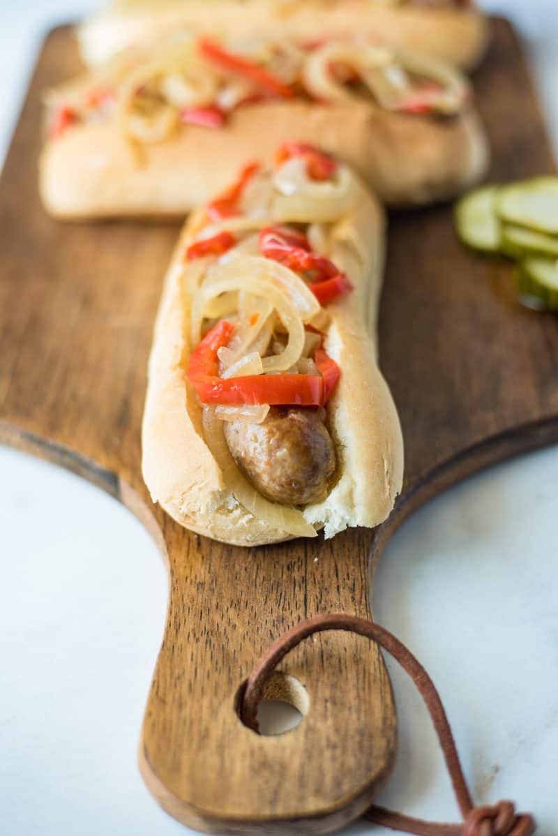 Slow cooker  beer brats with peppers and onions are the perfect, easy cookout meal for a crowd. Brats are slow cooked in German beer along with peppers and onions, pile onto a bun and you’re set.