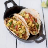 2 carnitas pork tacos with pineapple salsa