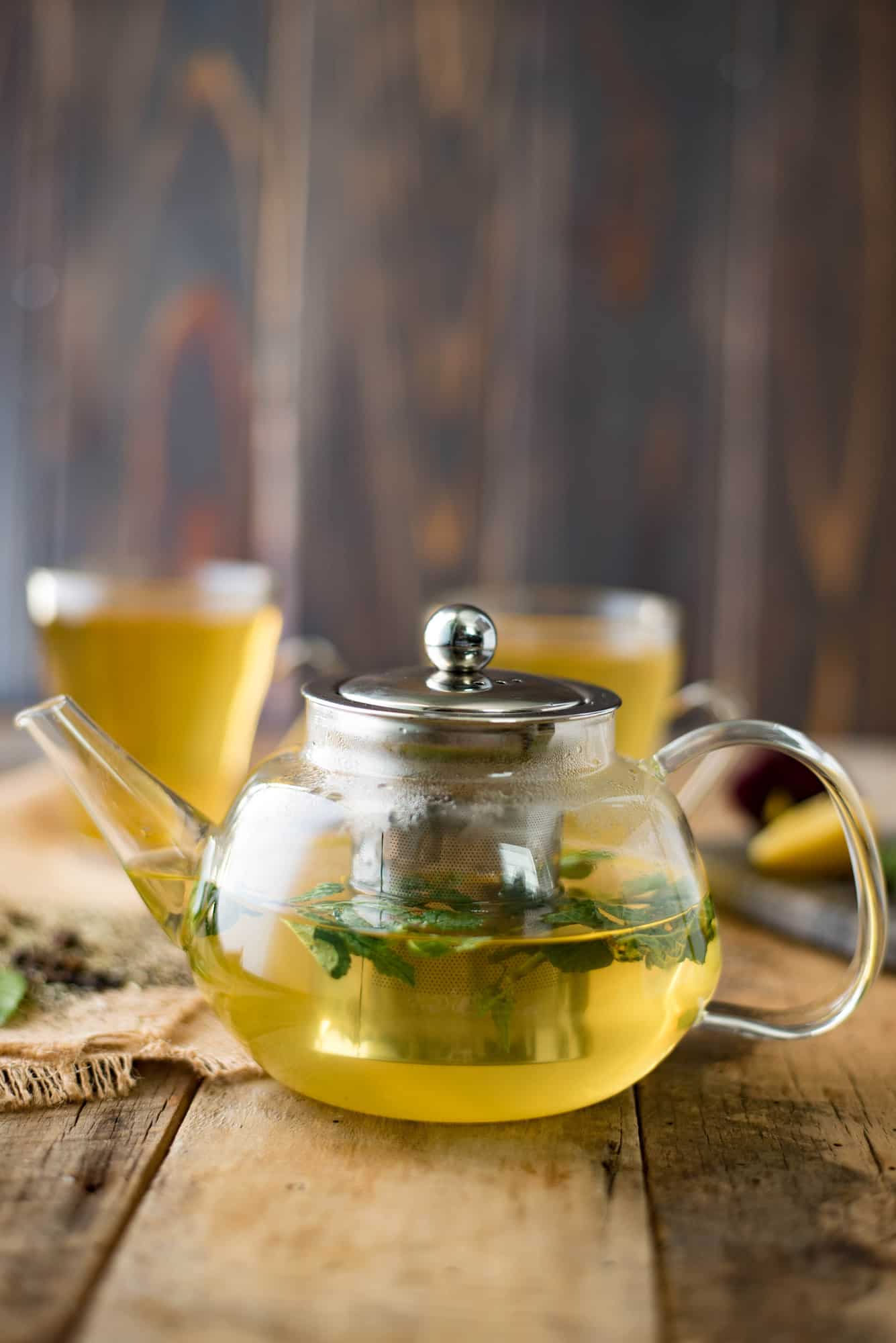 A side view of the herbal tea in a clear teapot