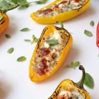 7 Sweet mini peppers on a serving board garnished with greens