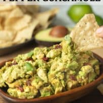 Spicy chipotle pepper guacamole in a wooden bowl