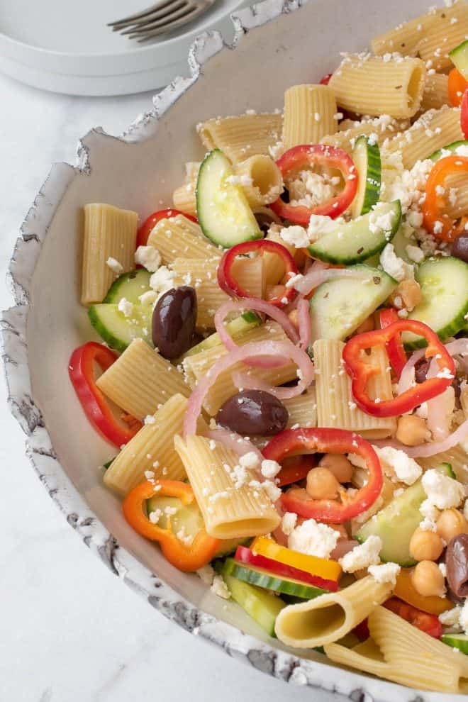 A closeup of colorful ingredients in a pasta salad