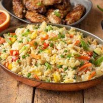 Colorful vegetable fried rice in an oval serving dish