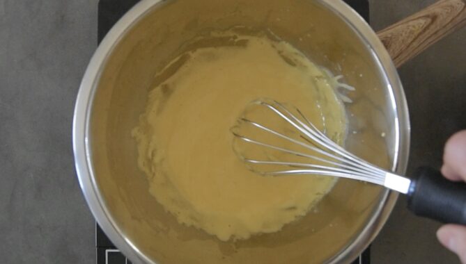 Egg yolks whisked to make a hollandaise sauce