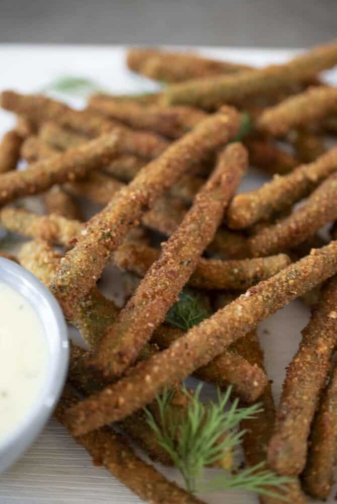 A closeup of a breaded and fried green bean