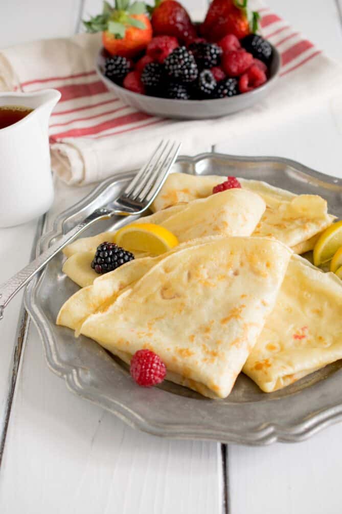 Thin folded pancakes served with berries