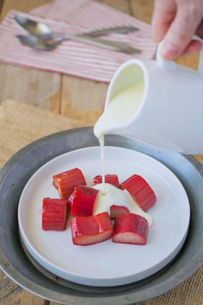 Pouring custard over rhubarb