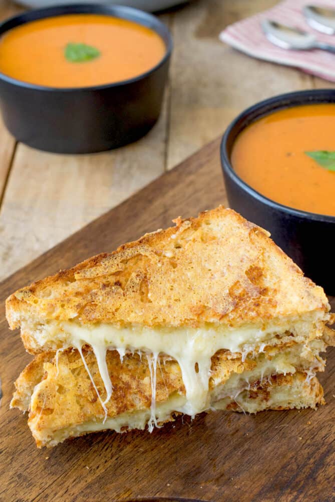 2 halves of a grilled cheese cut into triangles