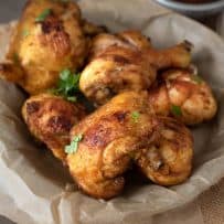 Turmeric Spiced Fried Chicken with Spicy Chili Sauce in a paper lined bowl