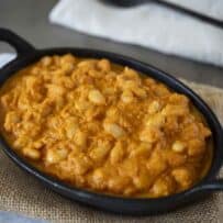 Baked beans in a tomato sauce served in an oval dish