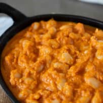 Navy beans in a thick, vegetable tomato sauce