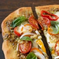 Colorful vegetable toppings on naan pizza